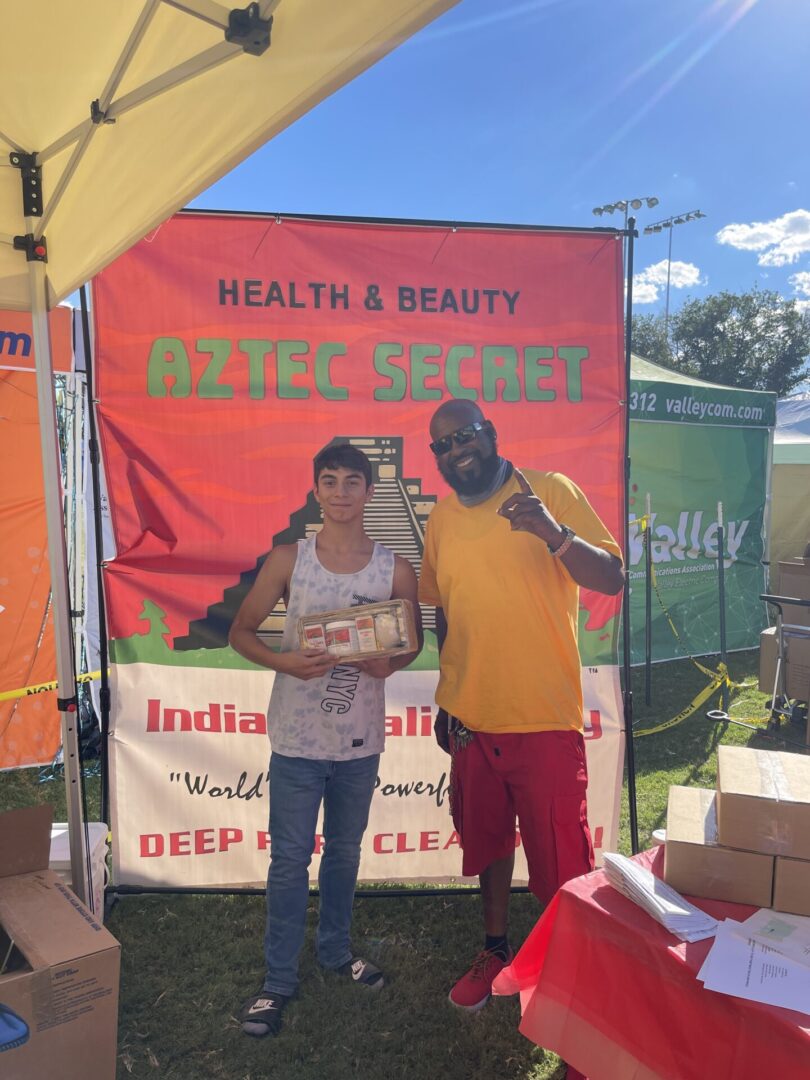 A young boy posing for a picture with the small infusion box | Aztec Secret Health & Beauty LTD